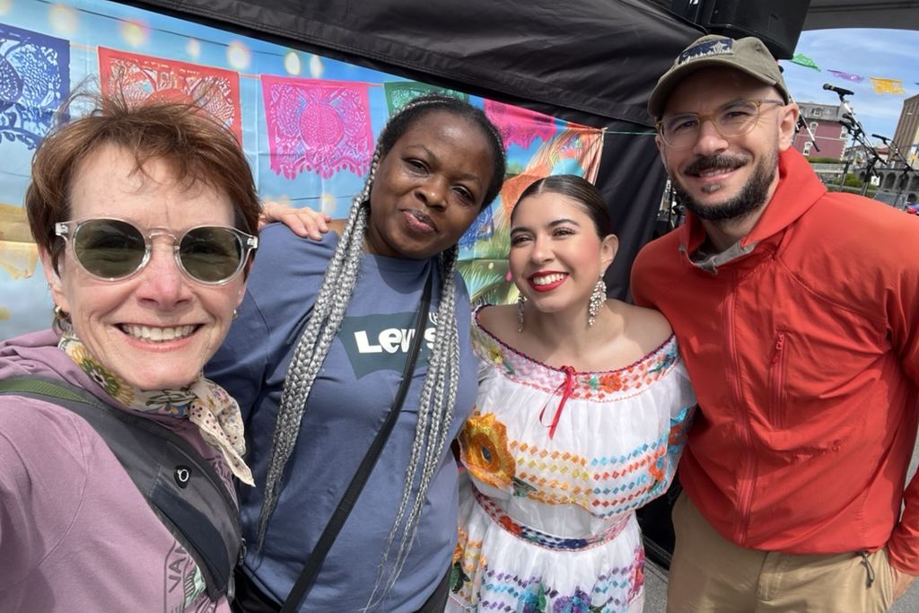 VICCIR staff and friends smiling together at an outdoor cultural festival